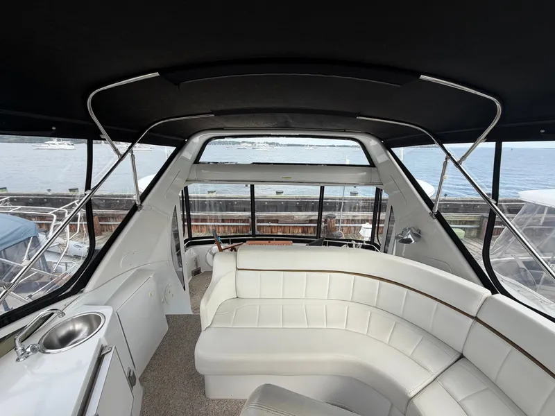 Slide: The Image of Interior of a 2002 Carver 396 Aft Cabin Motor Yacht with white leather seating. - 13