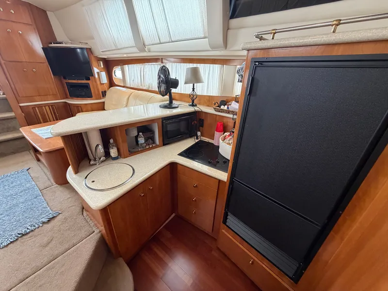 Slide: The Image of Interior of a 2002 Carver 396 Aft Cabin Motor Yacht with kitchen and living area. - 19