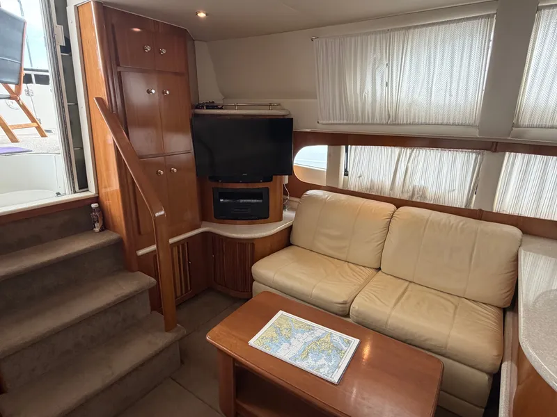 Slide: The Image of Interior of a 2002 Carver 396 Aft Cabin Motor Yacht with sofa and TV. - 17