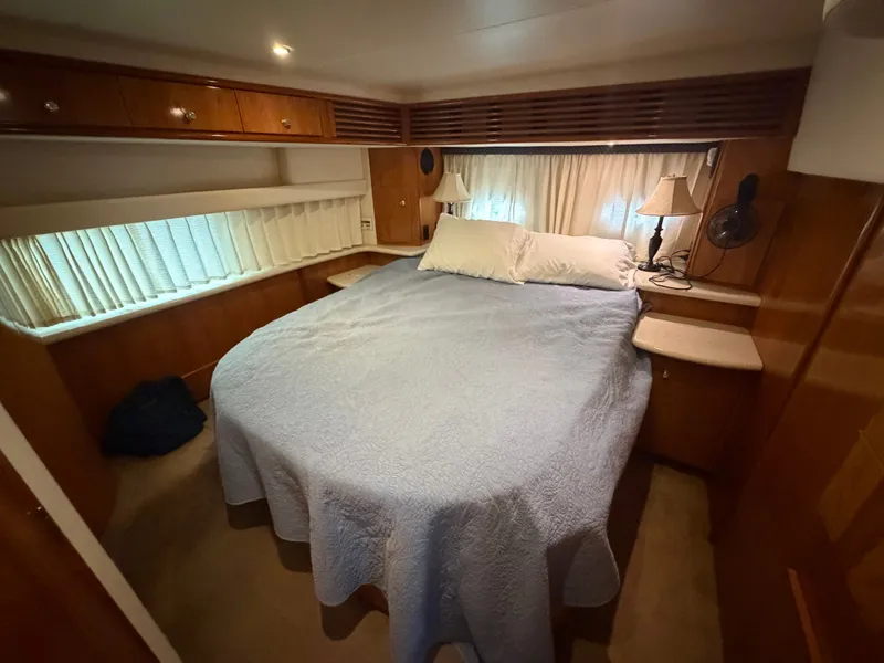 Slide: The Image of Cabin with double bed, wooden furnishings, and curtains, warmly lit. - 23