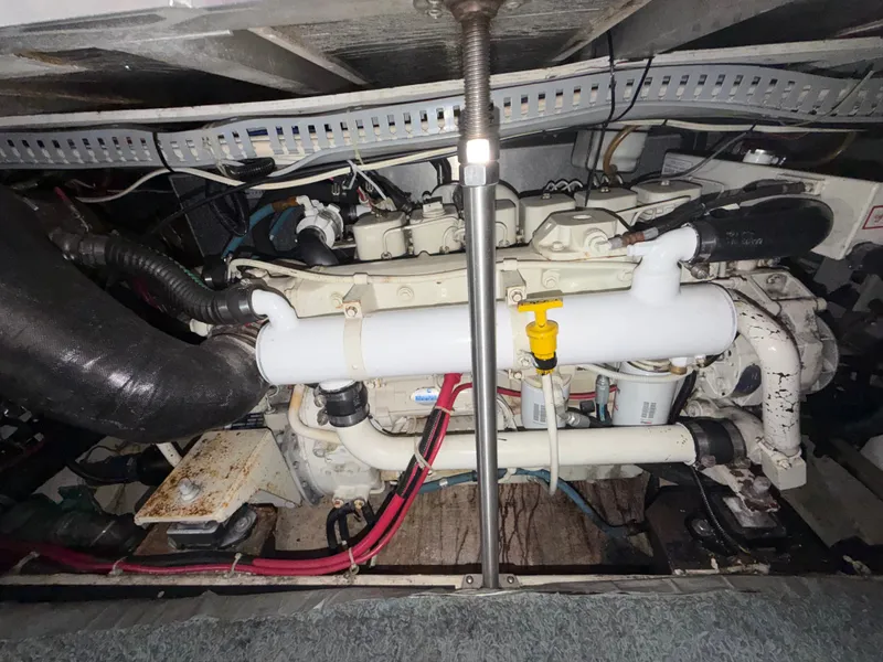 Slide: The Image of Engine room of a 2002 Carver 396 Aft Cabin Motor Yacht with visible pipes and cables. - 29
