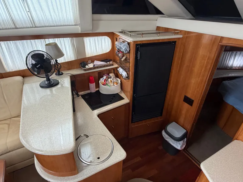 Slide: The Image of Interior of a 2002 Carver 396 Aft Cabin Motor Yacht with kitchen and seating area. - 18