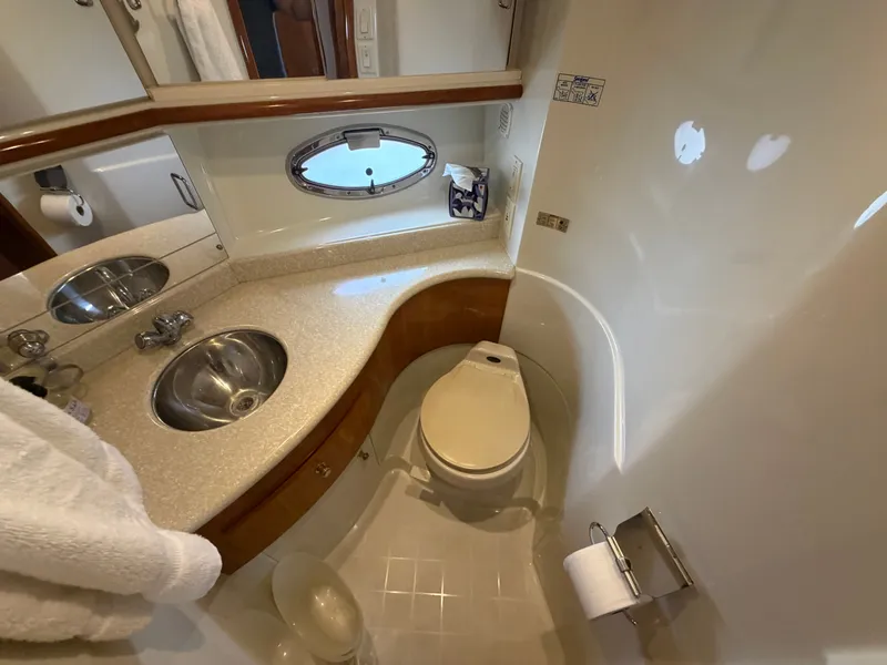 Slide: The Image of Bathroom in a yacht with a sink, toilet, and round window. - 22