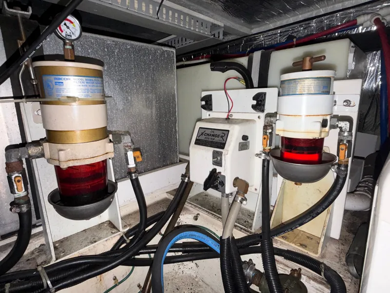 Slide: The Image of Engine room of Carver 396 Aft Cabin Yacht with filters and hoses. - 31