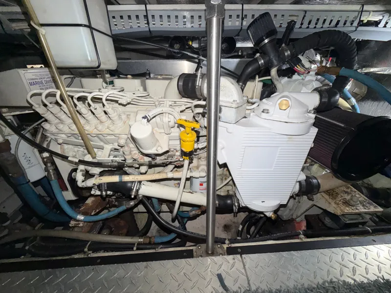 Slide: The Image of Engine room of a 2002 Carver 396 Aft Cabin Motor Yacht with visible engine and piping. - 28