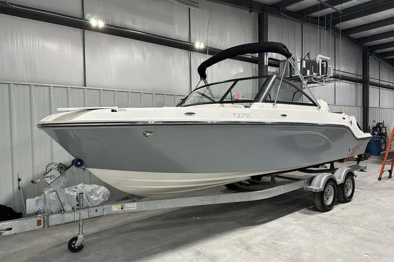 Slide: The Image of 2025 Bayliner Trophy T22SC boat on trailer in indoor storage facility. - 2