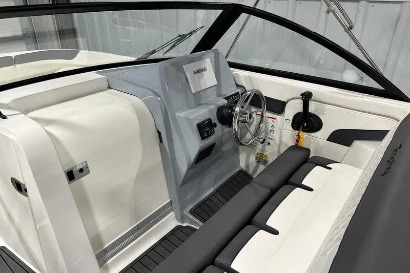 Slide: The Image of 2025 Bayliner Trophy T22SC boat interior with steering wheel and control panel. - 14