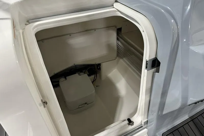 Slide: The Image of 2025 Bayliner Trophy T22SC storage compartment, open and empty, showcasing interior space. - 20