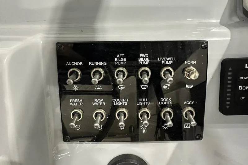Slide: The Image of Control panel of 2025 Bayliner Trophy T22SC boat with labeled switches. - 17