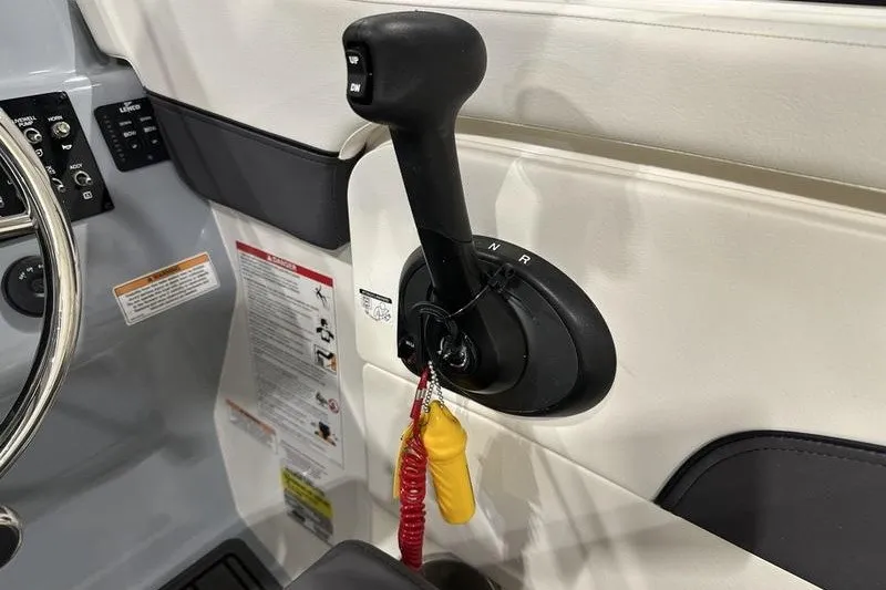 Slide: The Image of Control lever of 2025 Bayliner Trophy T22SC boat with safety lanyard attached. - 18