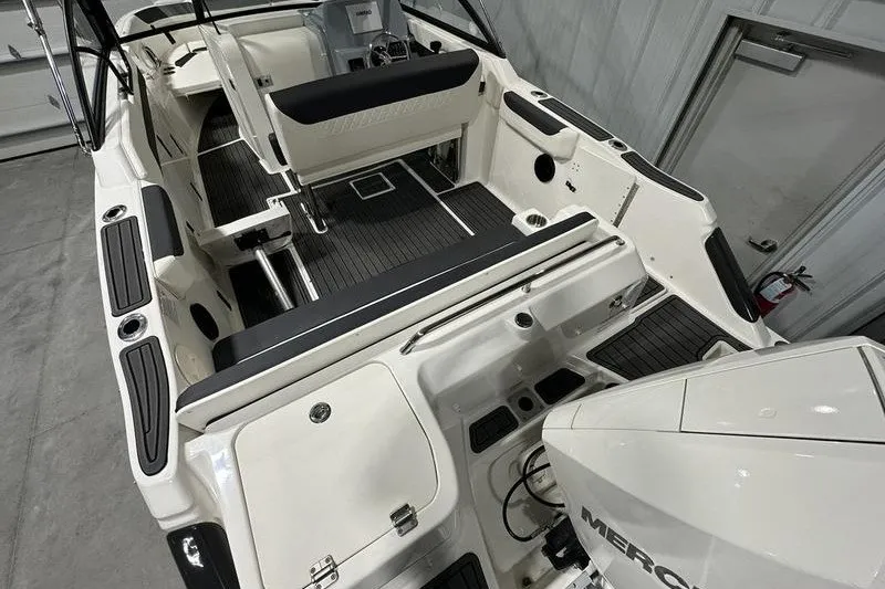 Slide: The Image of 2025 Bayliner Trophy T22SC boat interior with seating and Mercury engine. - 7