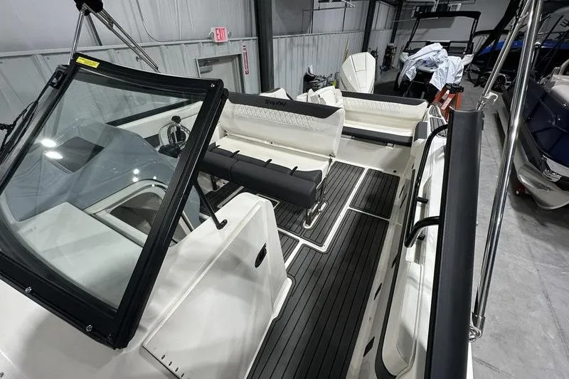 Slide: The Image of 2025 Bayliner Trophy T22SC boat interior with seating and steering console. - 22