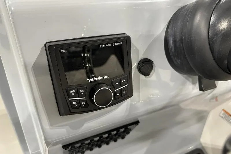 Slide: The Image of 2025 Bayliner Trophy T22SC dashboard with Rockford Fosgate audio system and controls. - 16