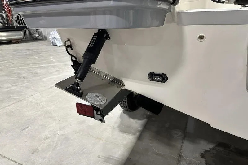 Slide: The Image of 2025 Bayliner Trophy T22SC boat's rear view with trim tab and hydraulic system. - 4