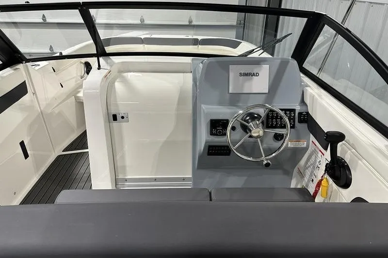 Slide: The Image of 2025 Bayliner Trophy T22SC boat interior with steering wheel and control panel. - 12