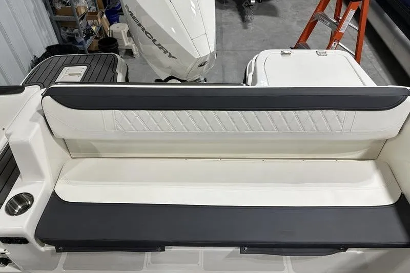 Slide: The Image of 2025 Bayliner Trophy T22SC boat interior with cushioned seating and Mercury engine. - 8