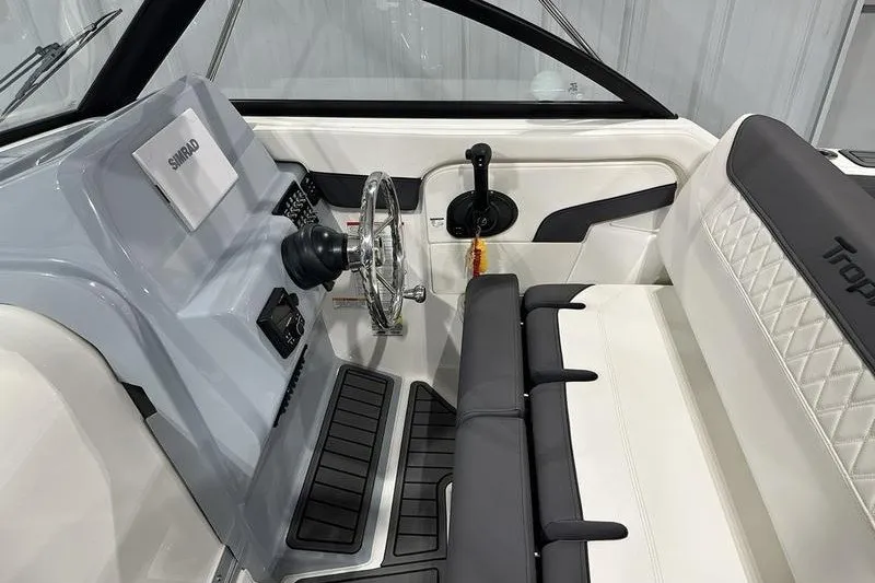 Slide: The Image of 2025 Bayliner Trophy T22SC boat interior with steering wheel and seating. - 15