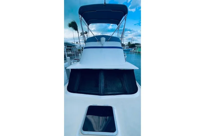 Slide: The Image of 1979 Bertram 31 Flybridge Cruiser docked, showcasing its sleek design and flybridge. - 25