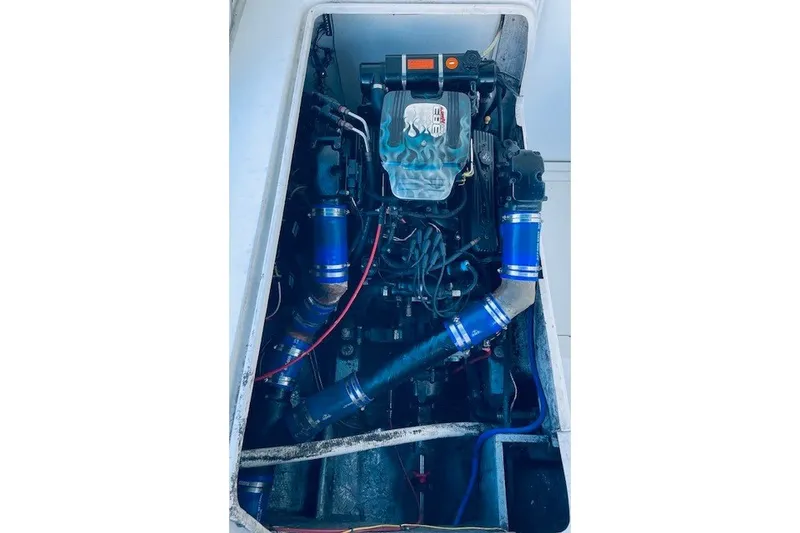 Slide: The Image of Engine compartment of a 1979 Bertram 31 Flybridge Cruiser with visible components and wiring. - 22