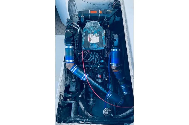 Slide: The Image of Engine compartment of a 1979 Bertram 31 Flybridge Cruiser with visible components and wiring. - 21