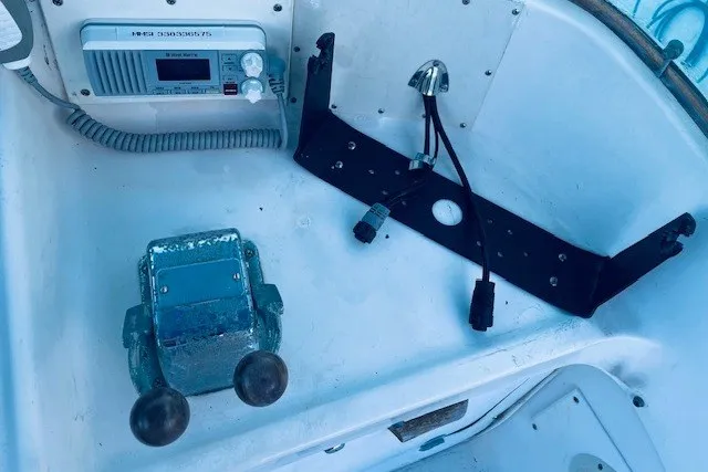 Slide: The Image of 1979 Bertram 31 Flybridge Cruiser cockpit with radio and control levers. - 23