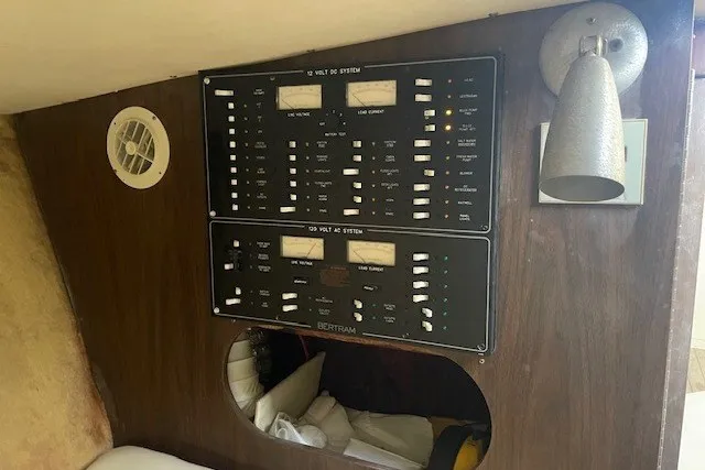 Slide: The Image of 1979 Bertram 31 Flybridge Cruiser electrical panel with switches and controls. - 12