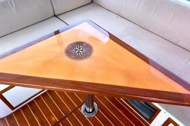 Slide: The Image of Triangular wooden table with compass design on a 2008 True North 34 boat. - 12