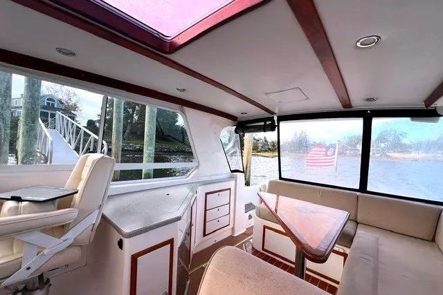 Slide: The Image of Interior of 2008 True North 34 boat with seating and table, overlooking water. - 13