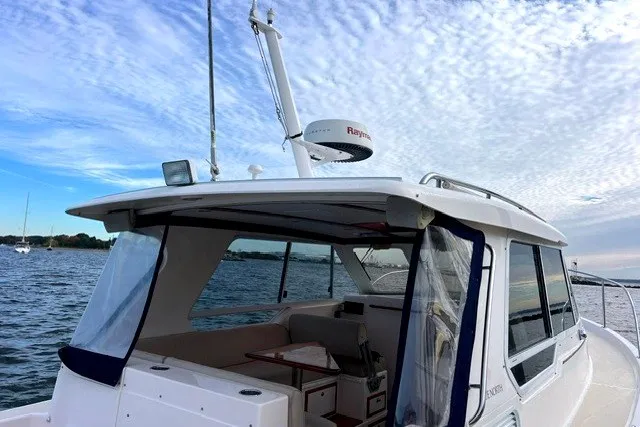 Slide: The Image of 2008 True North 34 boat on water under a cloudy sky. - 2