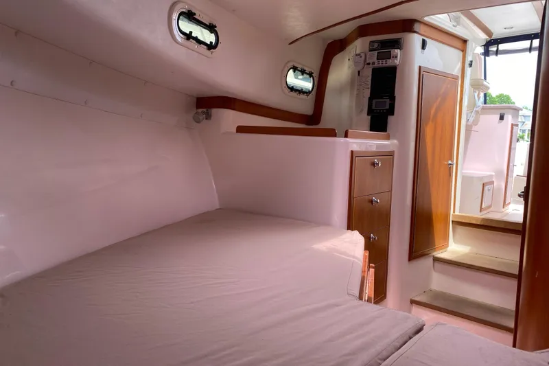 Slide: The Image of Interior of 2008 True North 34 boat with cozy cabin and wooden accents. - 14