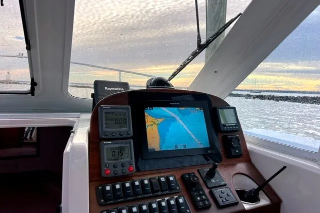 Slide: The Image of Cockpit view of 2008 True North 34 boat with navigation equipment and scenic water backdrop. - 6