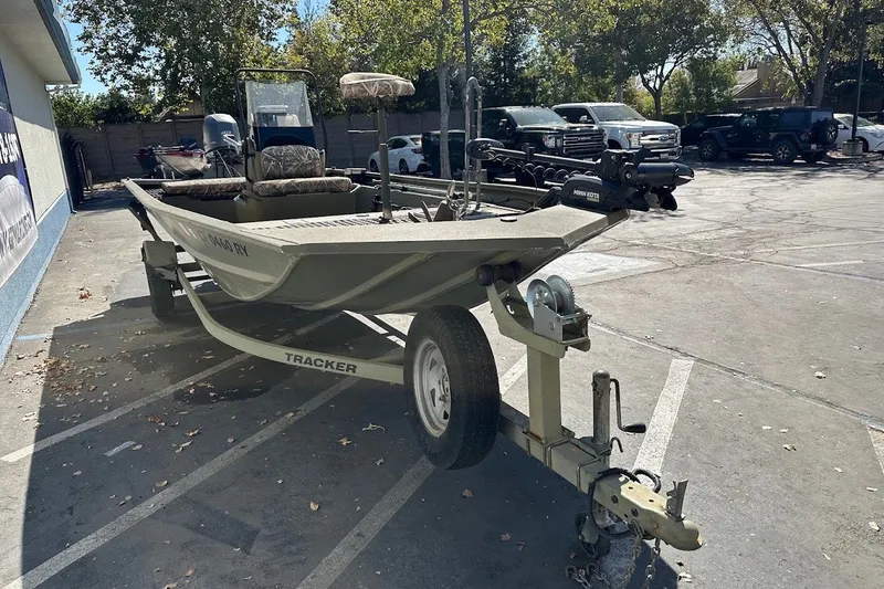 The Image of 2017 Tracker Grizzly 1860 MVX CC boat on trailer in parking lot. - 0