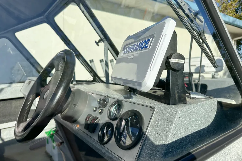 Slide: The Image of Interior of 2008 Jetcraft 1925 Adventurer boat with steering wheel and navigation system. - 8