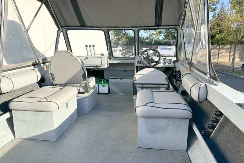 Slide: The Image of Interior of a 2008 Jetcraft 1925 Adventurer boat with seating and steering wheel. - 10