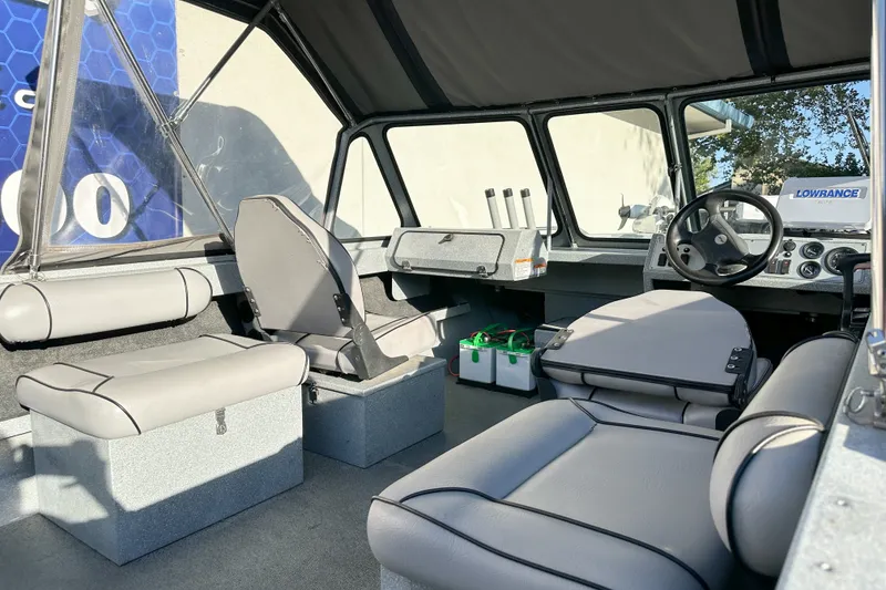 Slide: The Image of Interior of a 2008 Jetcraft 1925 Adventurer boat with seating and steering console. - 6