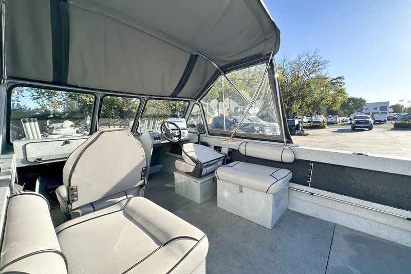Slide: The Image of Interior of 2008 Jetcraft 1925 Adventurer boat with seating and steering wheel. - 12
