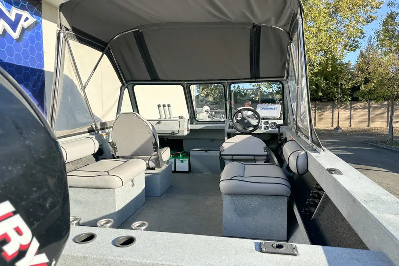 Slide: The Image of Interior of a 2008 Jetcraft 1925 Adventurer boat with seating and steering wheel. - 5