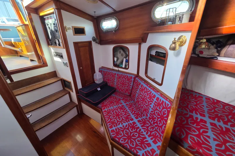 Slide: The Image of Cozy interior of 1998 Able Wolf Class 36 sailboat with red-patterned seating. - 31