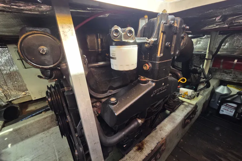 Slide: The Image of Engine compartment of a 1998 Able Wolf Class 36 boat, showcasing mechanical components. - 22