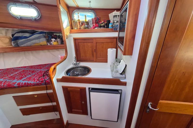 Slide: The Image of Compact wooden boat interior with sink, storage, and cozy sleeping area. Able Wolf Class 36, 1998. - 33