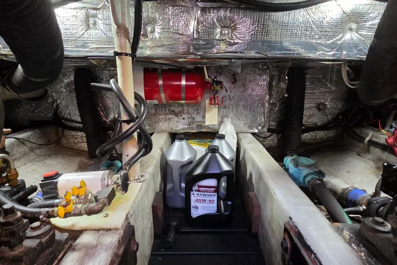 Slide: The Image of Engine room of a 1998 Able Wolf Class 36 boat with oil containers and fire extinguisher. - 24