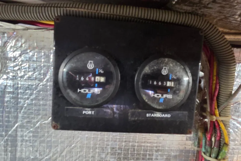 Slide: The Image of Engine hour meters on a 1998 Able Wolf Class 36 boat, showing port and starboard readings. - 26