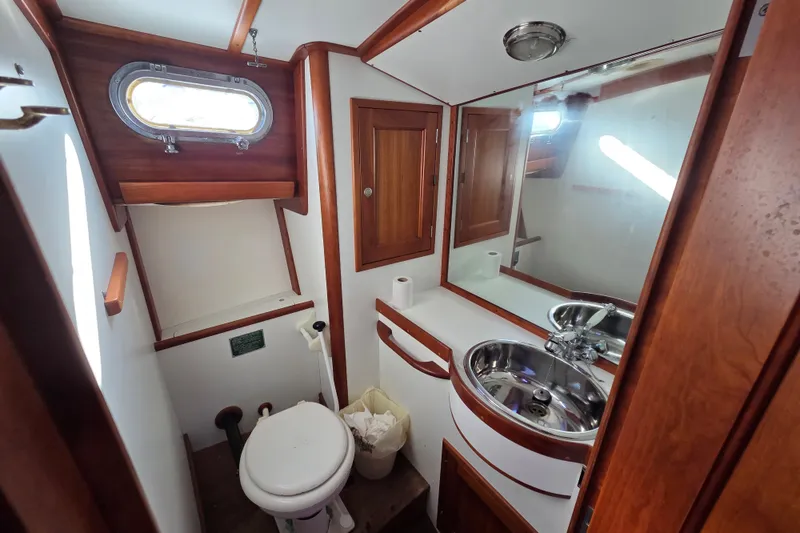 Slide: The Image of Bathroom interior of 1998 Able Wolf Class 36 yacht with wooden accents and stainless steel sink. - 32