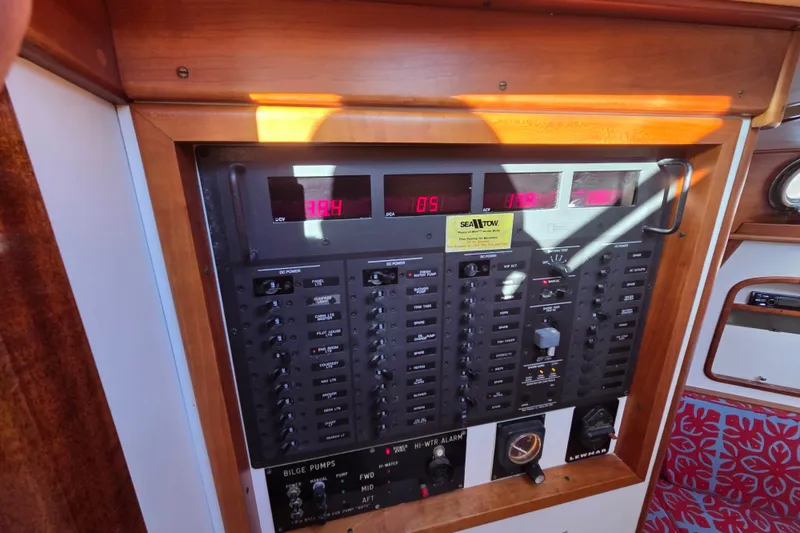 Slide: The Image of Electrical control panel on a 1998 Able Wolf Class 36 boat, featuring various switches and displays. - 27