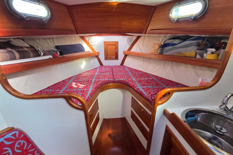 Slide: The Image of Cozy cabin interior of 1998 Able Wolf Class 36 sailboat with vibrant bedding and wooden accents. - 30