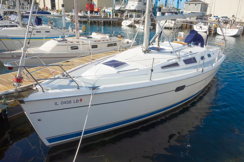 Slide: The Image of 2003 Hunter 356 sailboat docked at marina, surrounded by other boats. - 1