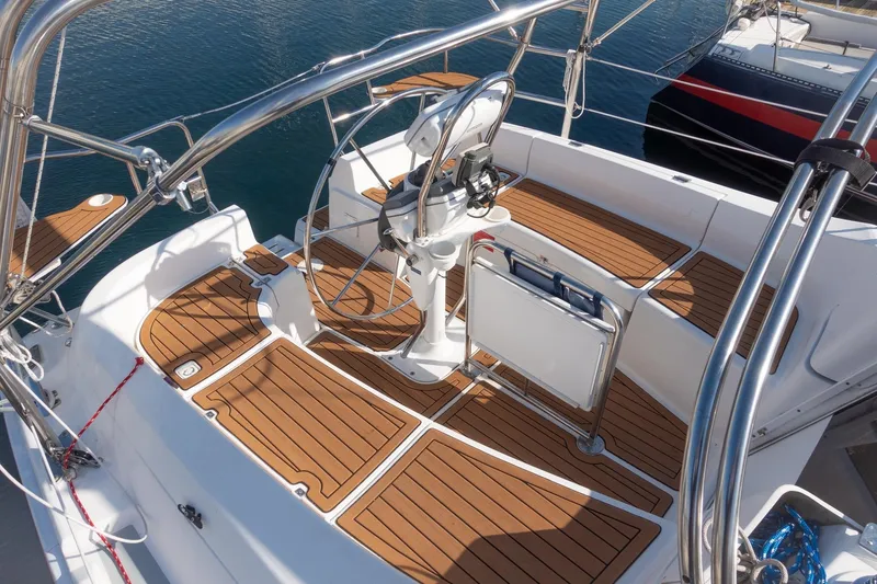 Slide: The Image of Cockpit of 2003 Hunter 356 sailboat with teak flooring and steering wheel. - 2