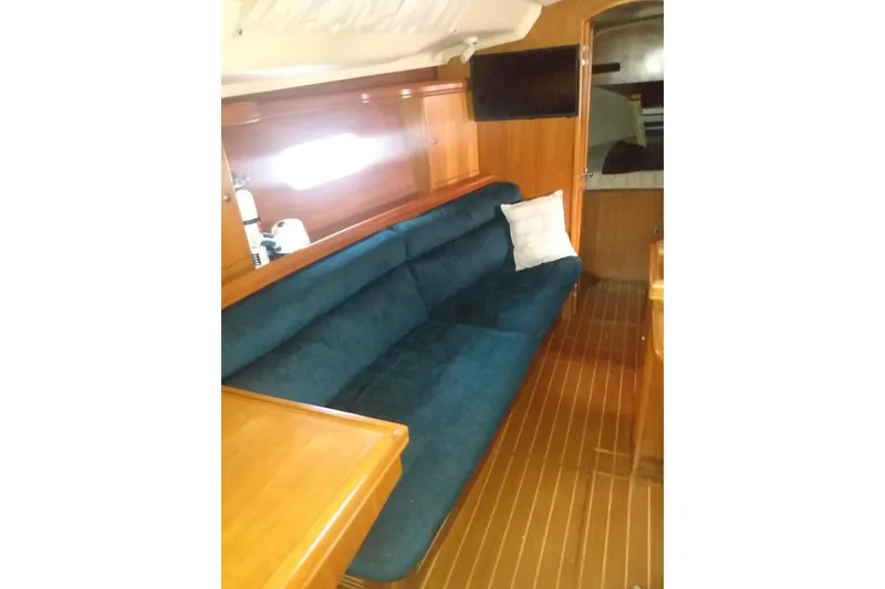 Slide: The Image of Interior of 2003 Hunter 356 sailboat with blue sofa and wooden finish. - 12