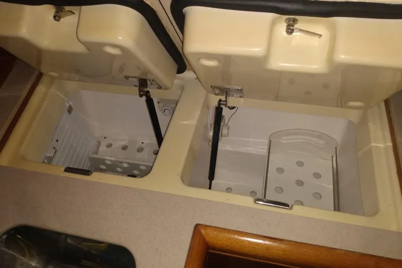 Slide: The Image of Open storage compartments in a 2003 Hunter 356 boat interior. - 14