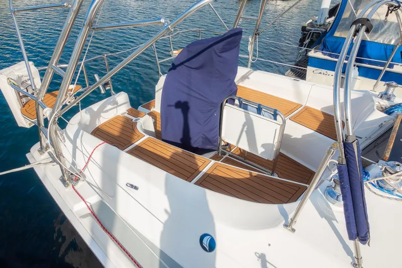 Slide: The Image of 2003 Hunter 356 sailboat cockpit with teak flooring and covered helm, docked at marina. - 4
